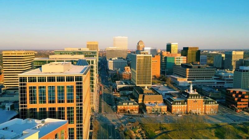 Aerial view of the Clayton, Missouri skyline, with the downtown office towers lit by low sun