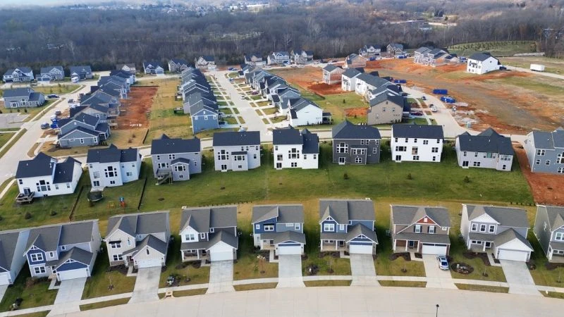 Aerial view of rows of newly built two-story homes in a subdivision still under construction in O'Fallon, MO