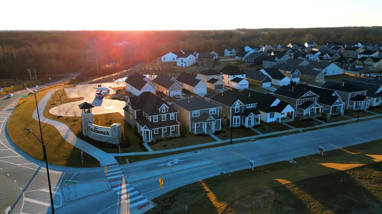New homes beside the Streets of Caledonia entrance monument at sunset, O'Fallon, MO