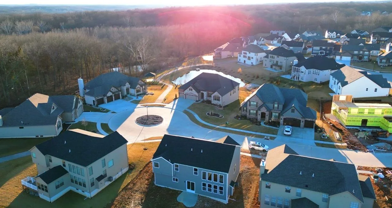 New homes on a cul-de-sac in Streets of Caledonia, O'Fallon, MO, with one still being framed
