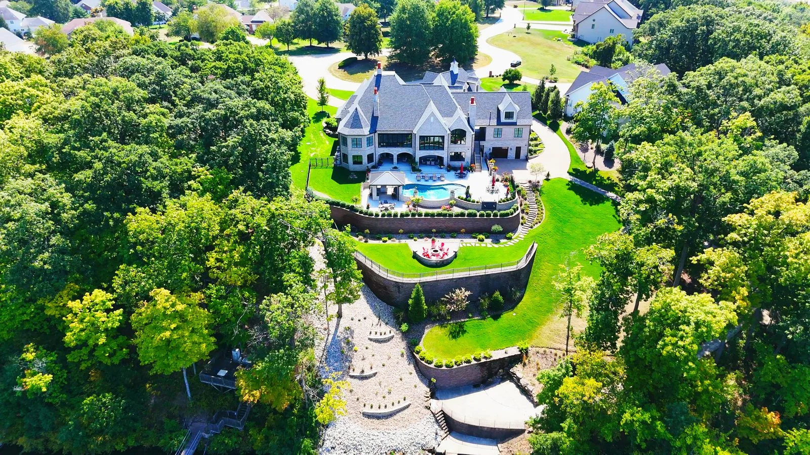 Luxury waterfront home with a pool and terraced yard in Lake St. Louis, MO