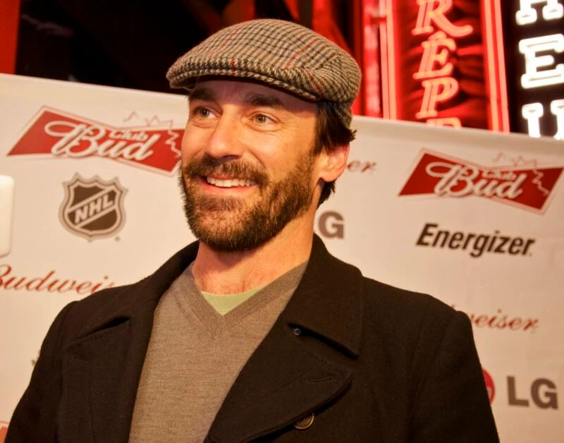 Jon Hamm wearing a flat cap at a promotional event