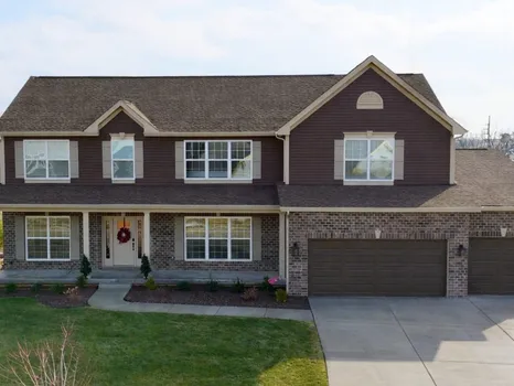 116 Royal Troon — two-story brick-and-siding home on a waterfront lot