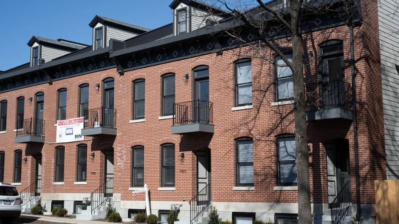 A terrace of new red-brick townhomes with mansard roofs at Salena and Pestalozzi