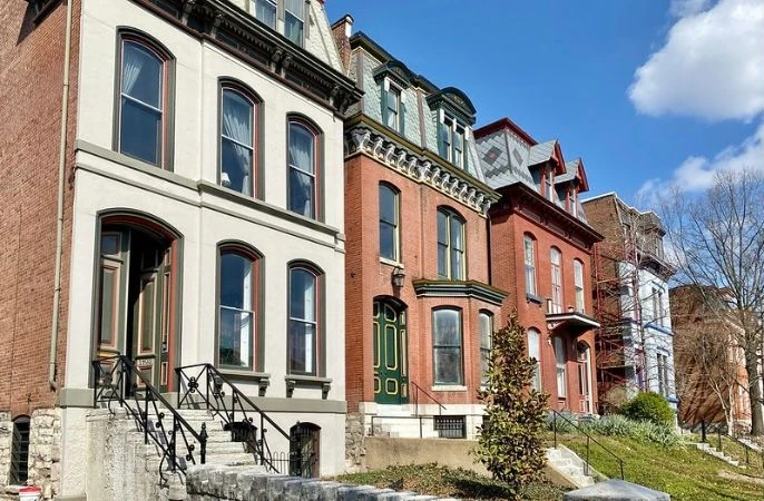 Row of restored Victorian townhouses with bay windows on a Lafayette Square street