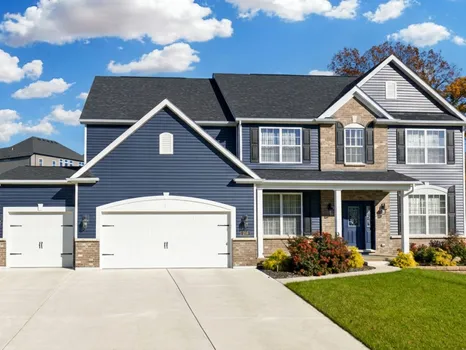 216 Everett Creek Court, O'Fallon, MO — navy two-story home with brick and three-car garage