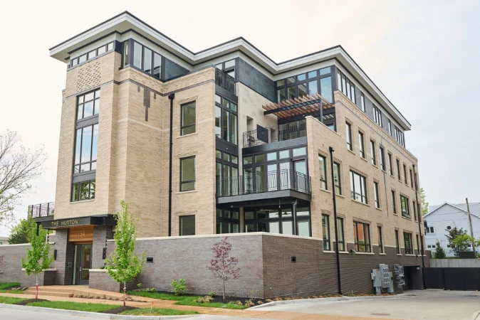 The Hutton Residences, a modern four-storey condo building in brick and glass
