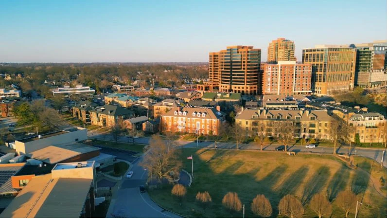 Downtown Clayton at golden hour, seen across the low-rise neighborhoods to its west