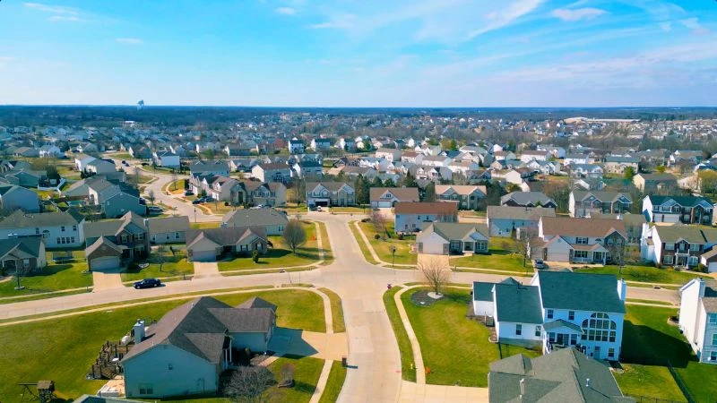 Aerial view of a Wentzville subdivision of two-story homes on curving streets