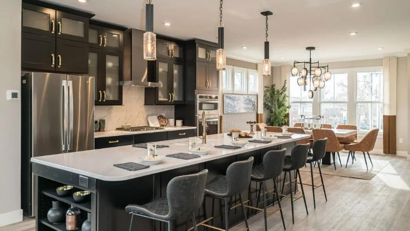 The finished main level of the Clifton display model, looking across the kitchen island to the living area