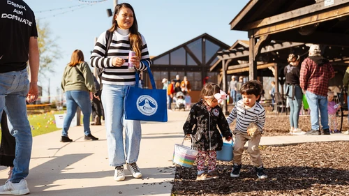 A family carrying Easter baskets at the Cottleville Easter Egg Hunt