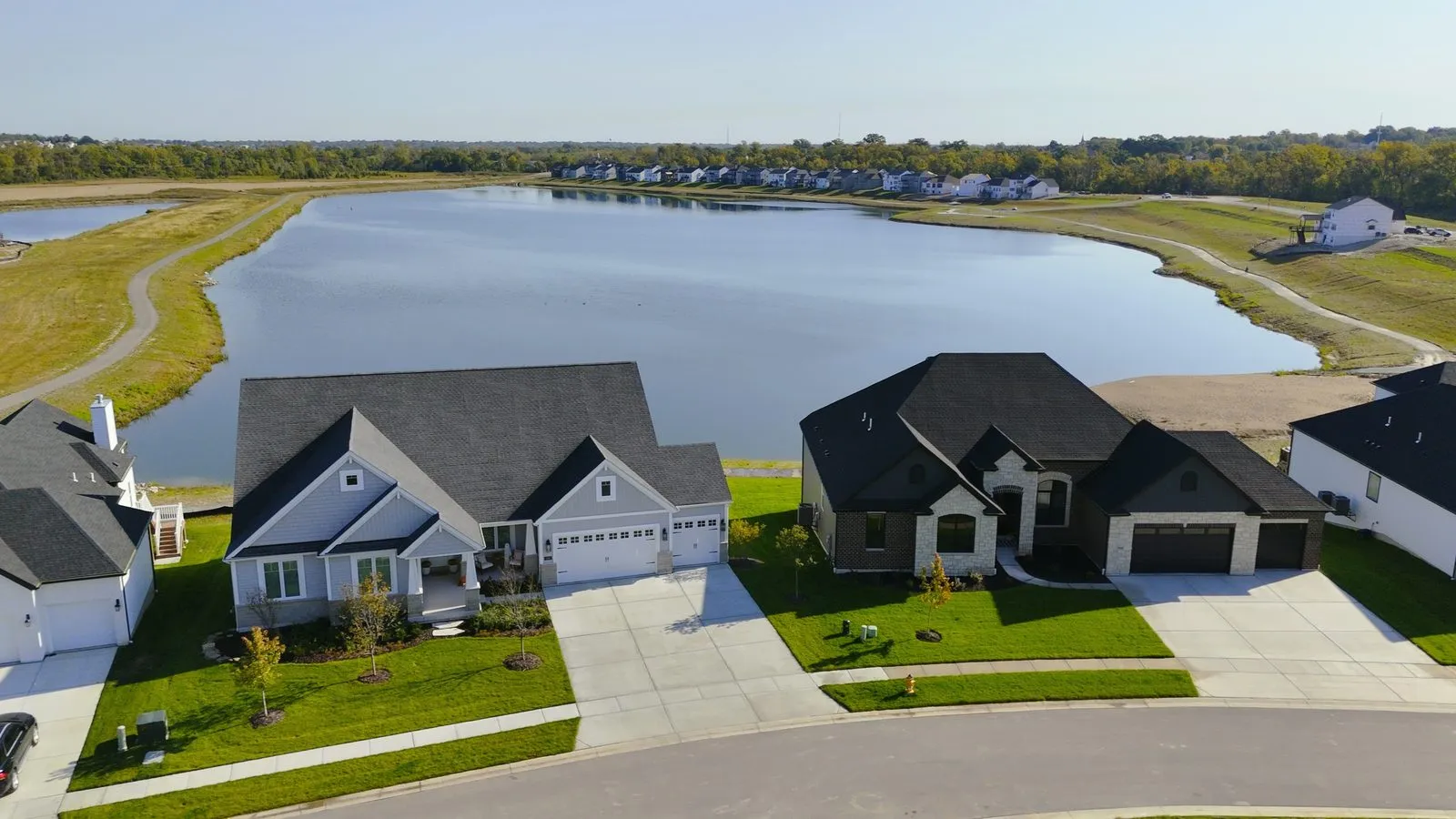 Aerial photograph of homes at Cottleville Trails backing onto one of the community lakes in October 2024, with the water filling the foreground
