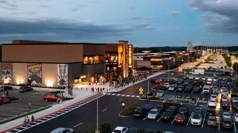 Crowd lined up outside The Factory at The District entertainment complex in Chesterfield at dusk