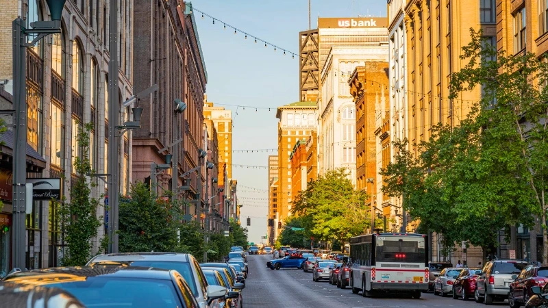 Daytime street-level view down Washington Avenue in Downtown St. Louis, lined with historic mid-rise buildings