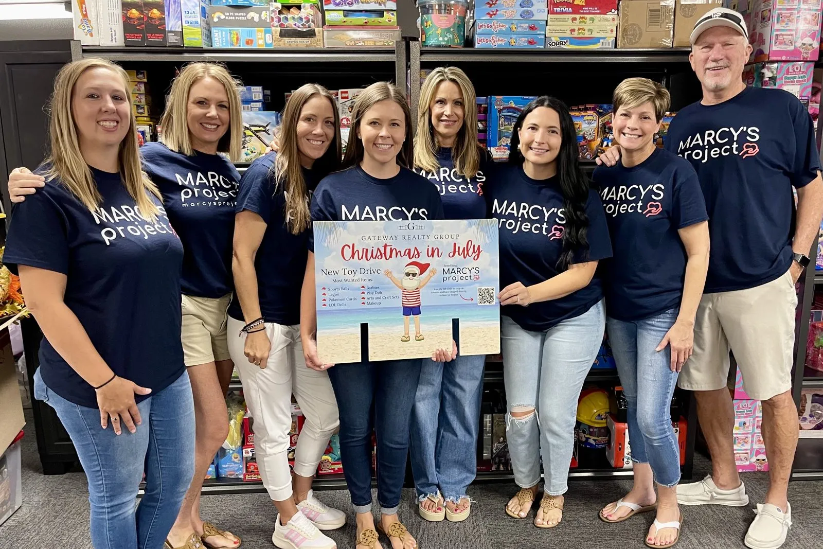 Madison Hayes and the Gateway Realty Group team in Marcy's Project shirts at their Christmas in July toy drive