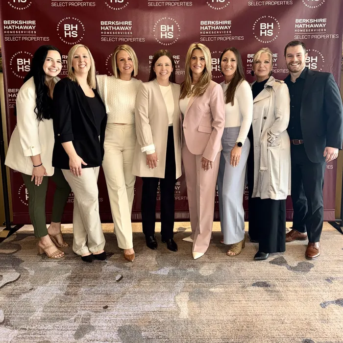 The Gateway Realty Group team in front of a Berkshire Hathaway HomeServices Select Properties backdrop