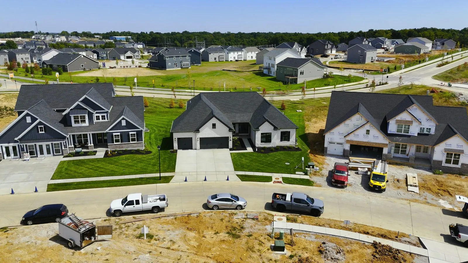 Aerial photograph of finished Fischer & Frichtel homes at Harvest in August 2025 with one of the community ponds and open common ground beyond them