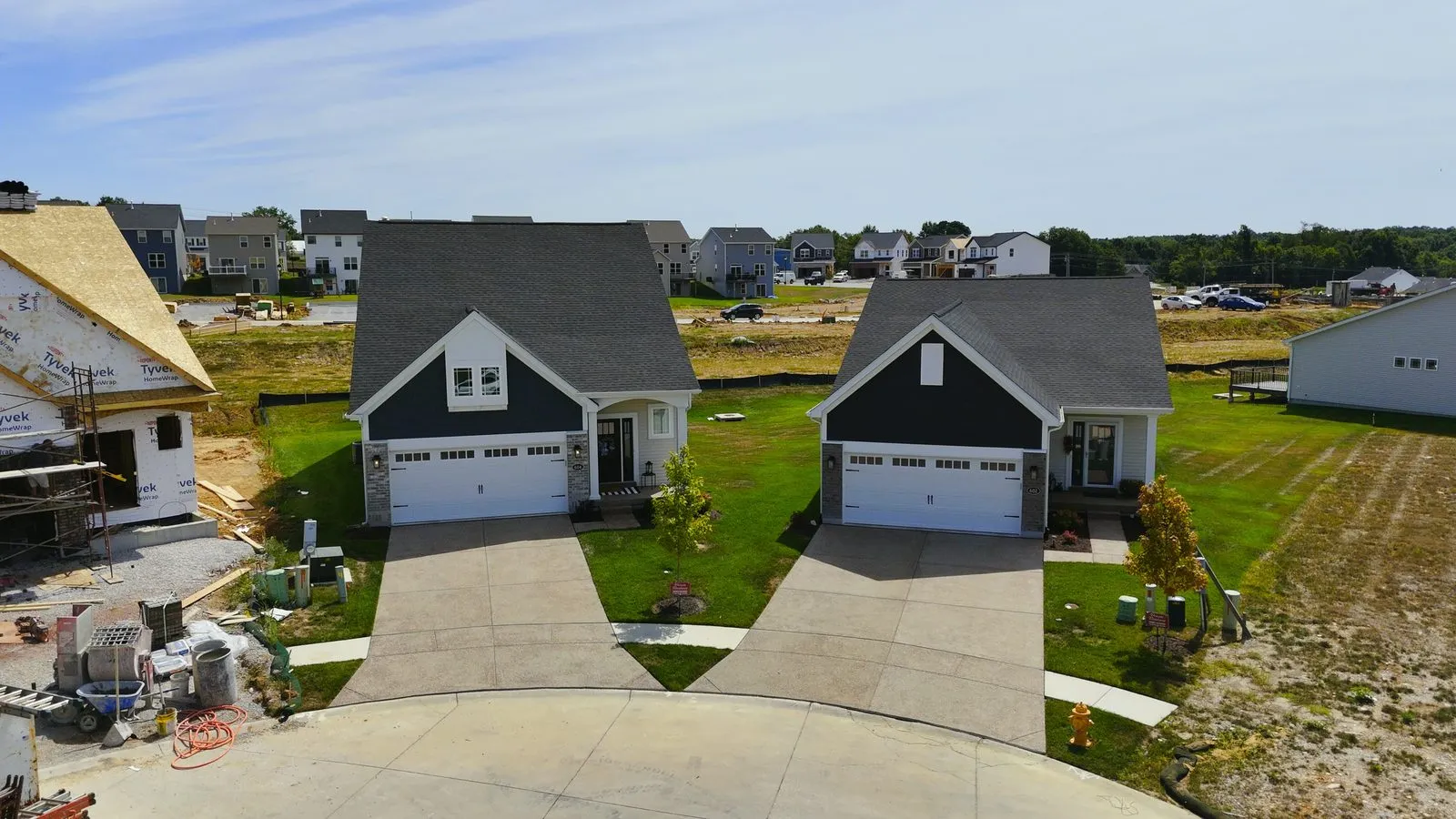 Completed free-standing villas built by Fischer & Frichtel at Harvest in August 2025, single level homes with two-car garages on a finished street