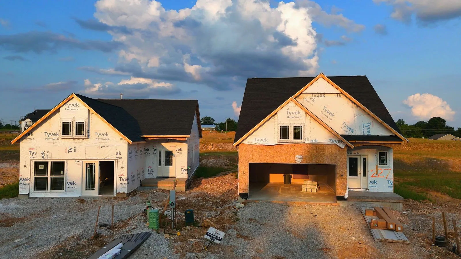 Aerial photograph of Fischer & Frichtel villas under construction at Harvest in July 2024, foundations and framing along a newly paved road