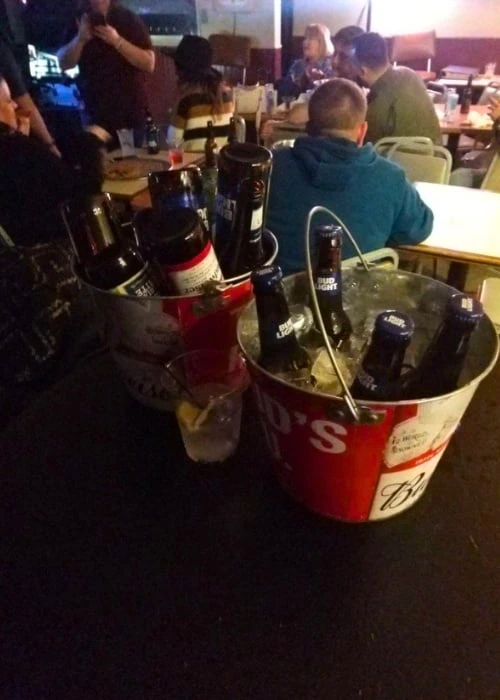 Beer buckets on the bar and a full crowd at Jo's 5th Street Pub in Old Town Cottleville