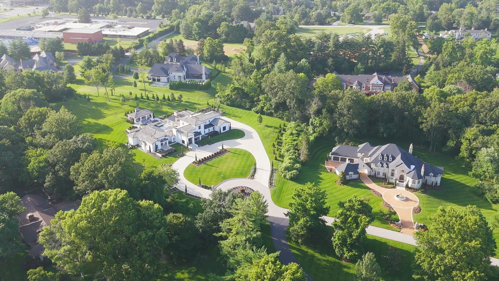 Aerial view of two large estates on Somerset Downs in Ladue, Missouri, with 25 Somerset Downs at right and 28 Somerset Downs at left
