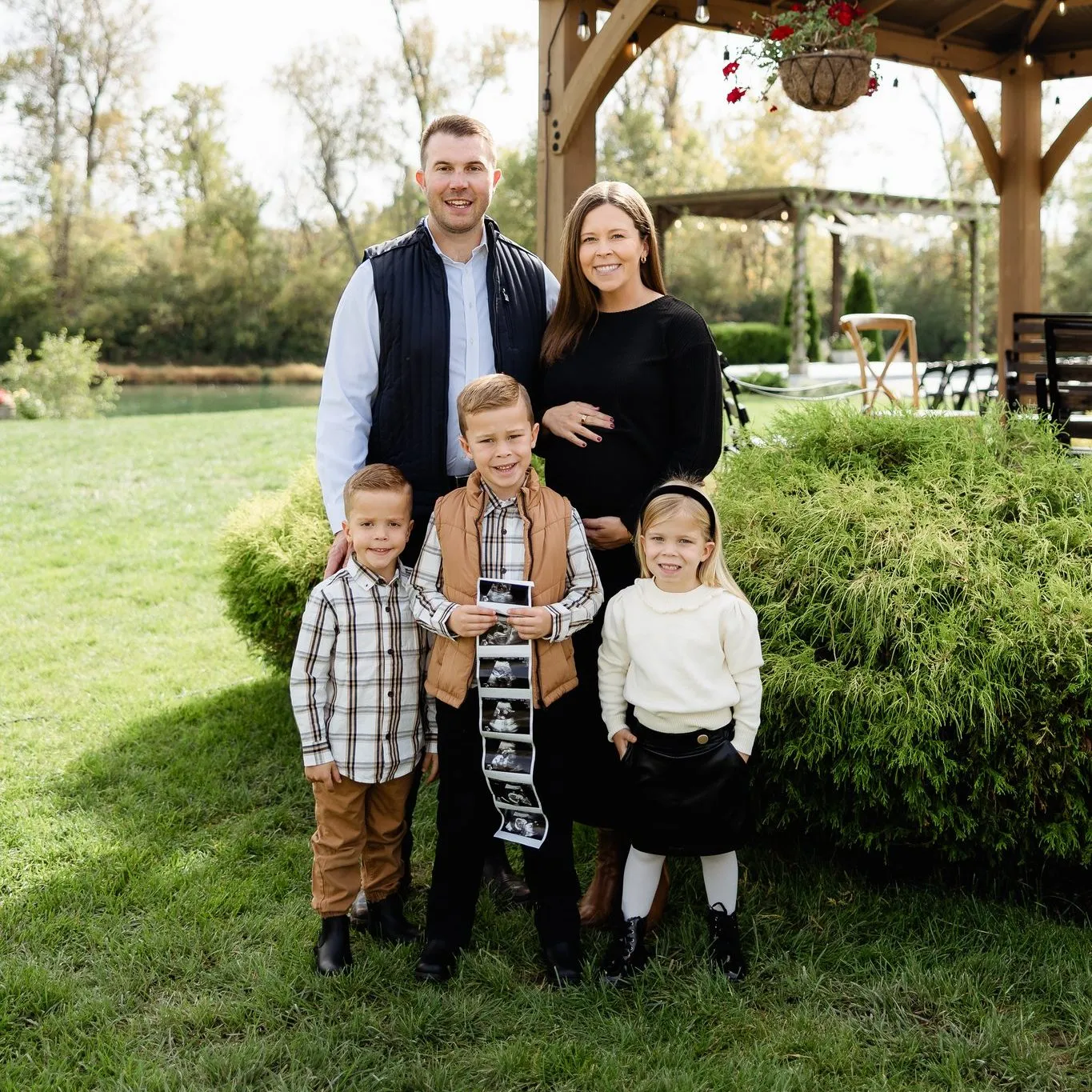 Madison Hayes, her husband and their three kids in a fall family photo announcing their fourth baby