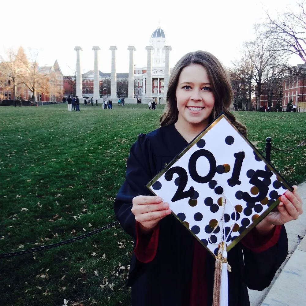 Madison Hayes in her cap and gown at the Columns on the University of Missouri campus in 2015