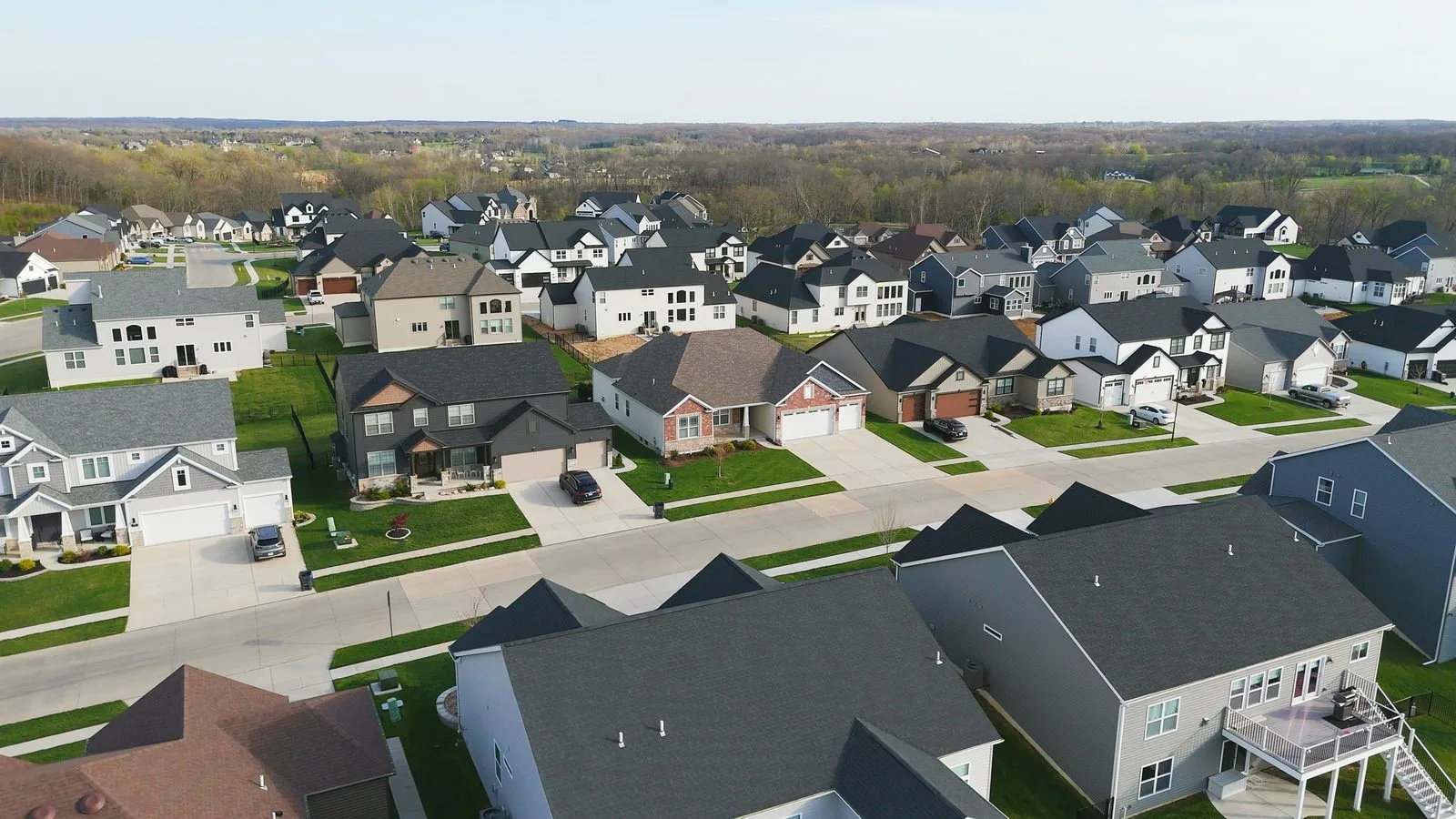 Aerial view of newer two-story homes built by Lombardo Homes in the Amberleigh neighborhood, O'Fallon, MO, April 2026