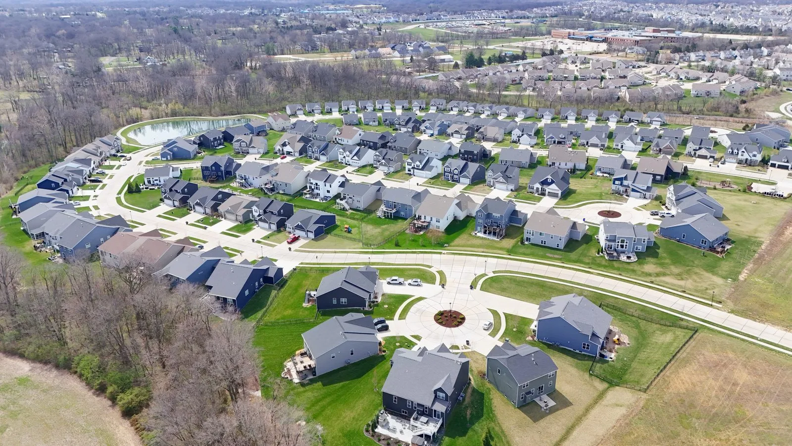 Aerial view of a new construction community in O’Fallon, Missouri built around a pond