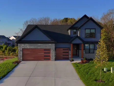 New Madison II by McKelvey at Cottleville Trails — two-story siding home with stone-and-wood accents