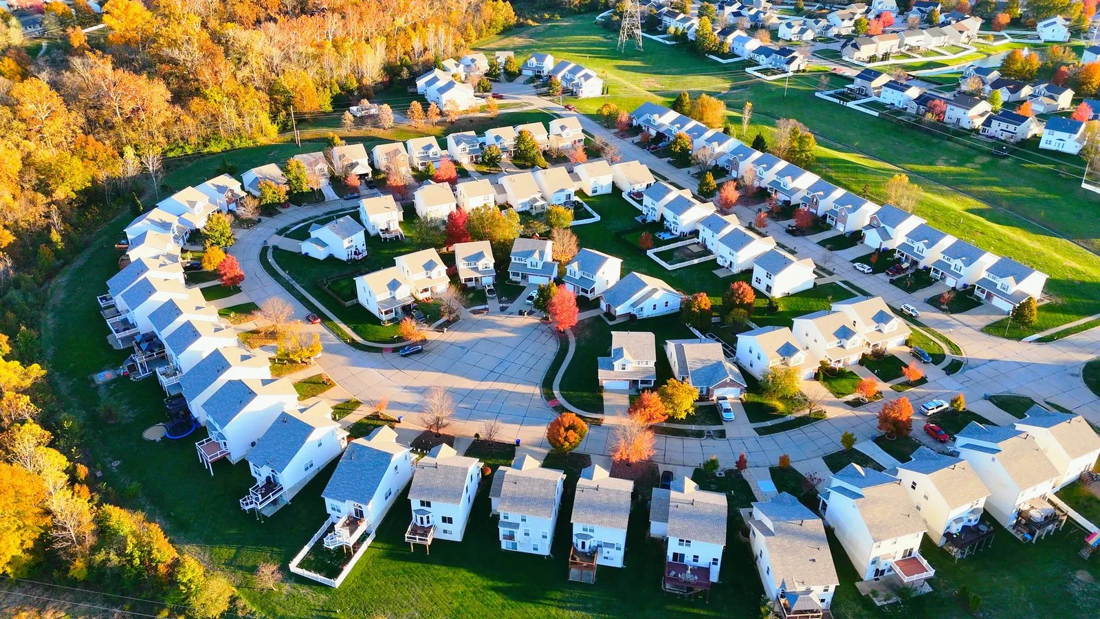 Aerial view of a dense suburban neighborhood of smaller two-story homes on similar lots in O'Fallon, MO