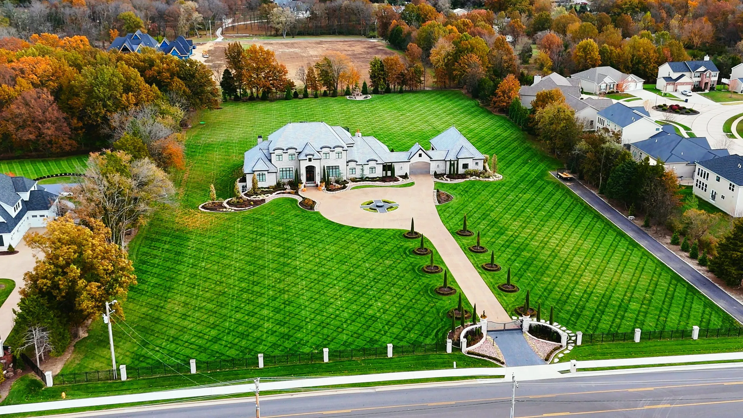 Aerial view of a large custom home with a gated entrance in O'Fallon, Missouri