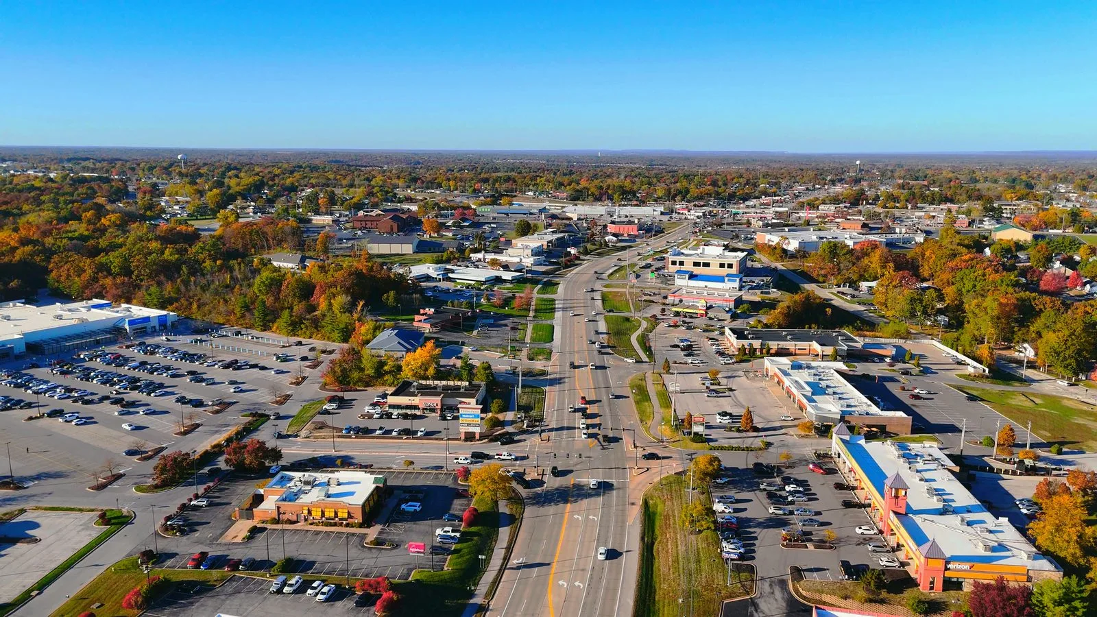 Aerial view looking north along Highway K through O'Fallon, MO, with commercial strips on both sides
