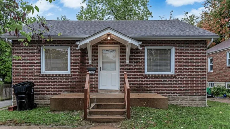 A small single-storey brick bungalow with a covered stoop, in Ward 3