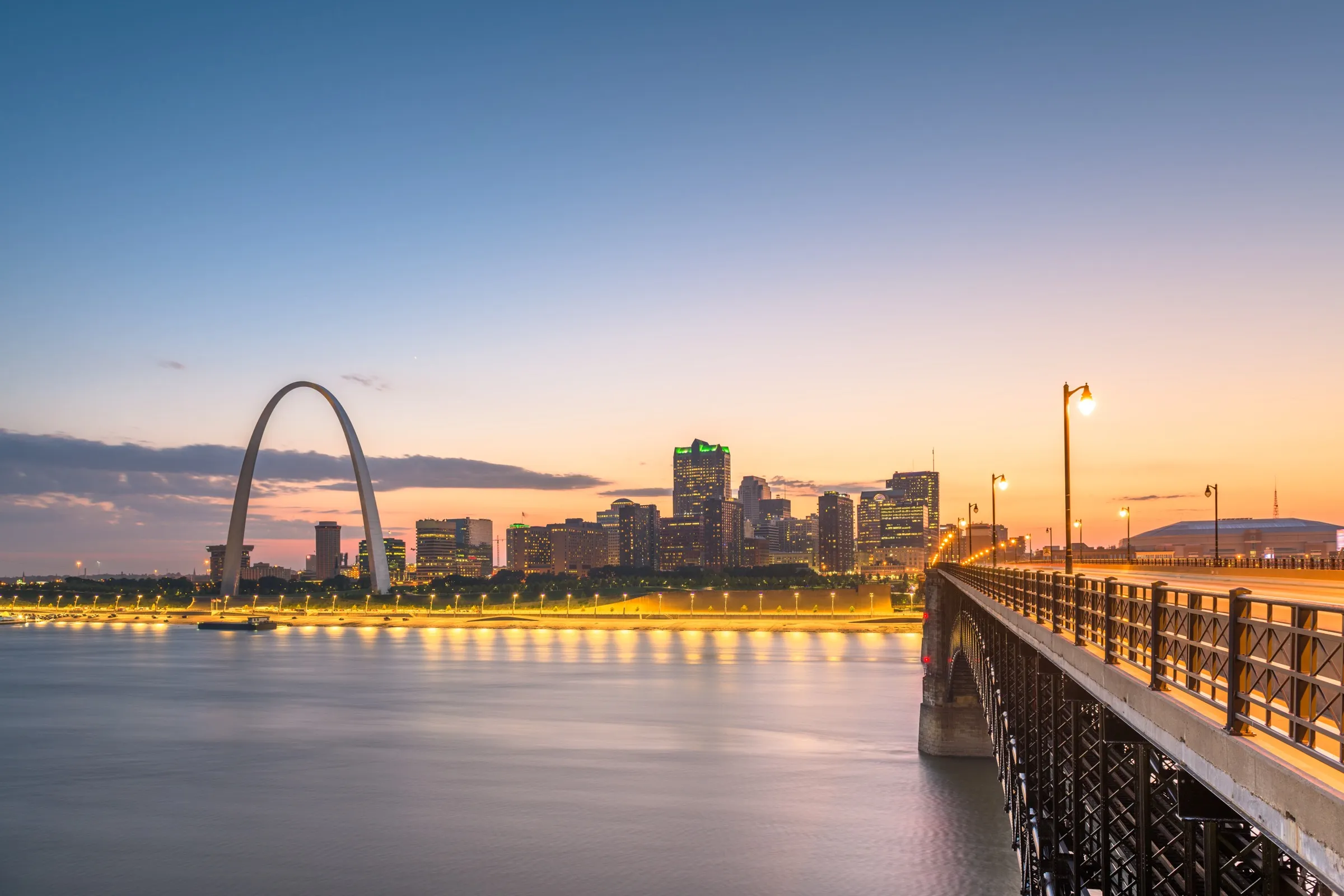 Gateway Arch and the Mississippi River bridge at sunset