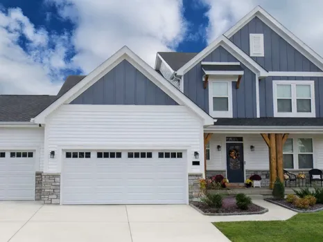 Streets of Caledonia home by Fischer Homes — white-and-grey two-story with double garage