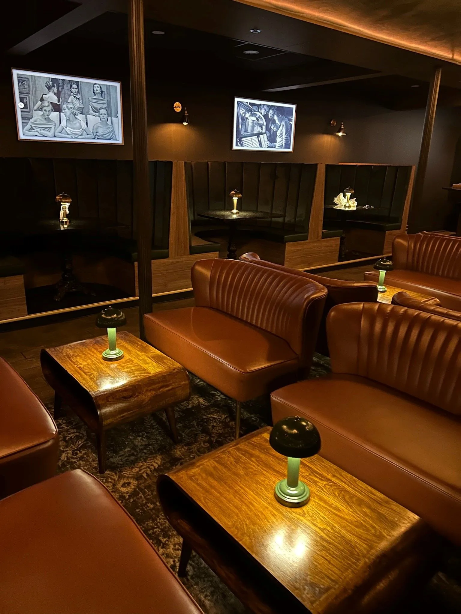 Leather booths and vintage photographs inside The Root of the Oak speakeasy under the Oak Street Inn in Cottleville