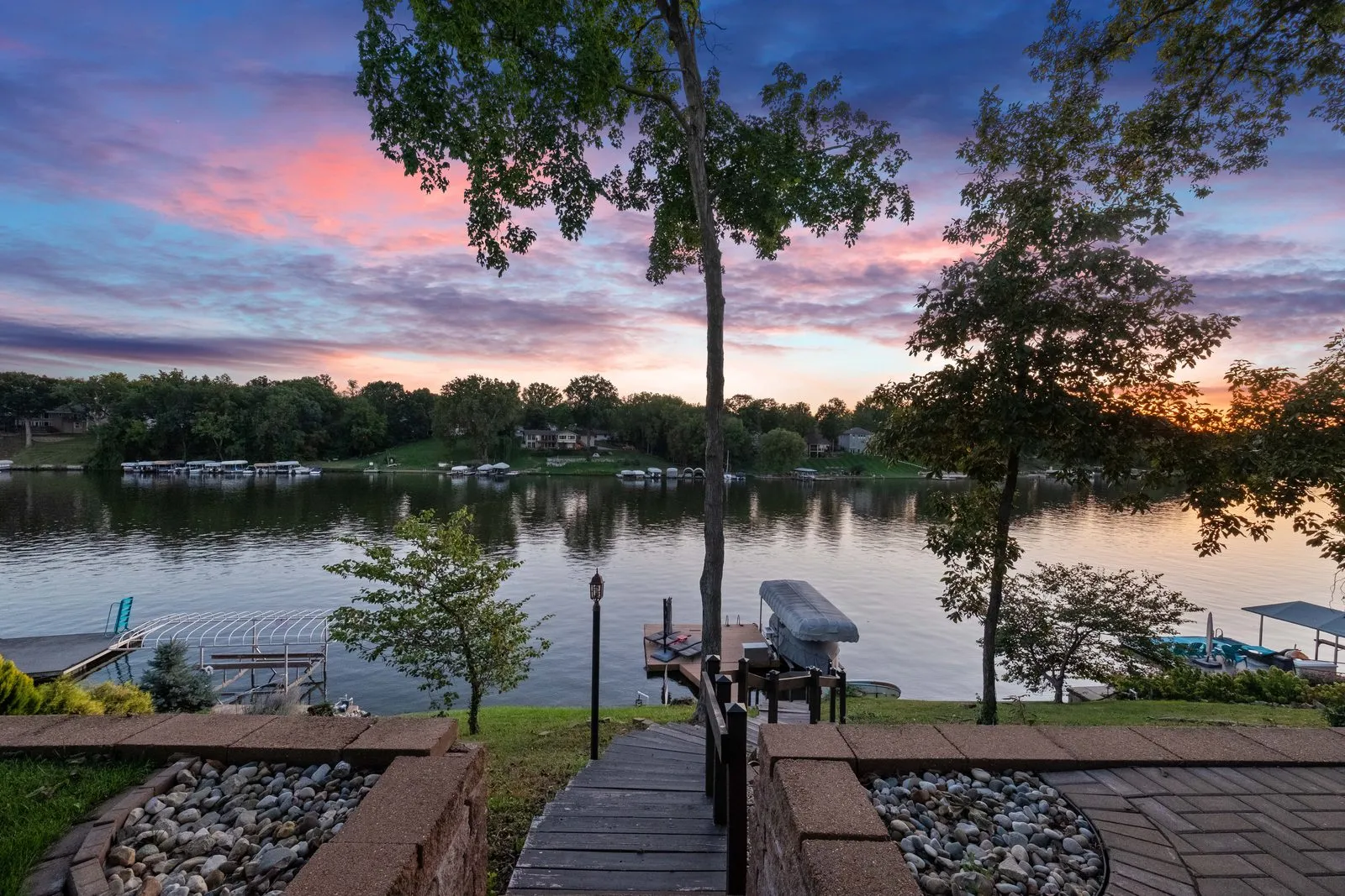 Dusk view across the lake from the property’s dock and patio