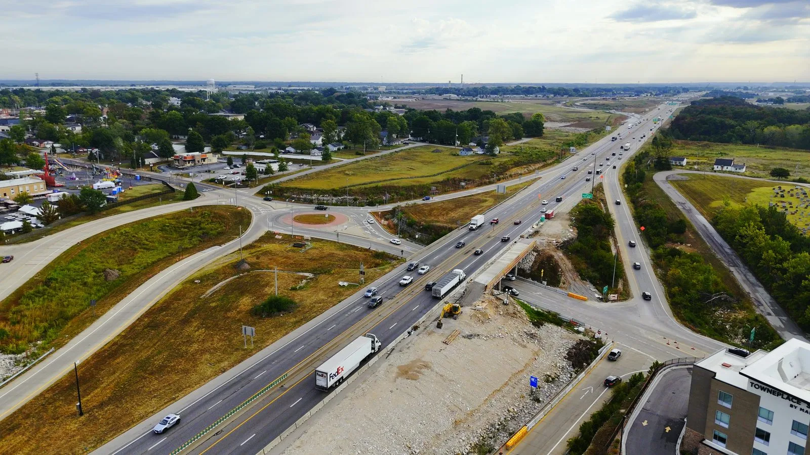 Aerial view of the I-70 and Route Z interchange in Wentzville with a bridge under construction, the roundabout ramps, and the TownePlace Suites hotel in the foreground