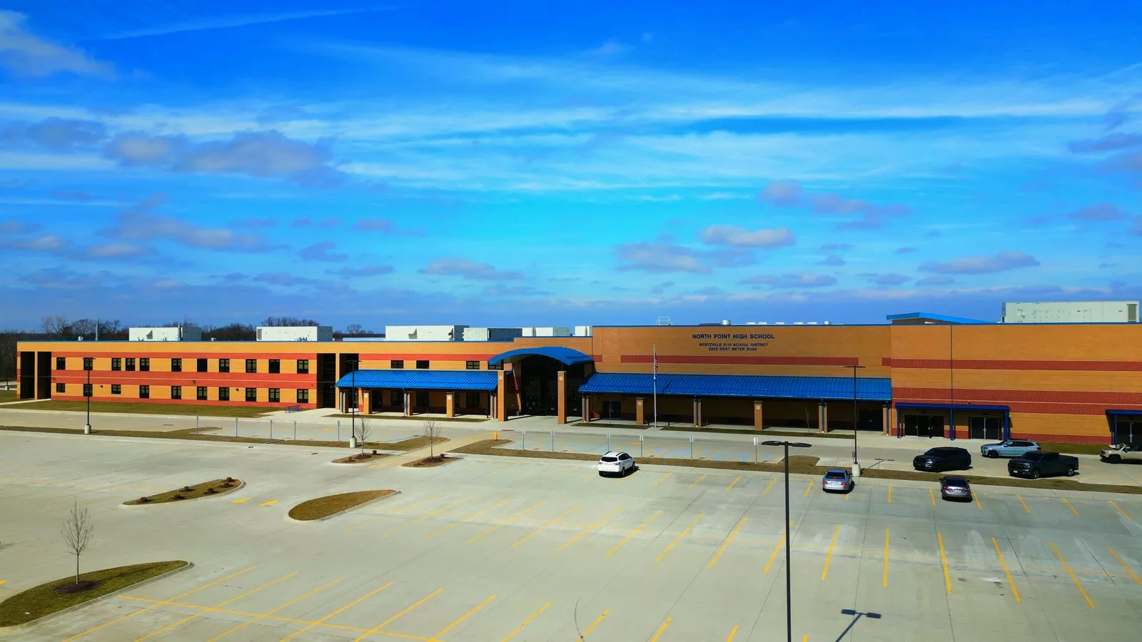 The brick front entrance and parking lot of North Point High School in Wentzville, part of the Wentzville R-IV School District