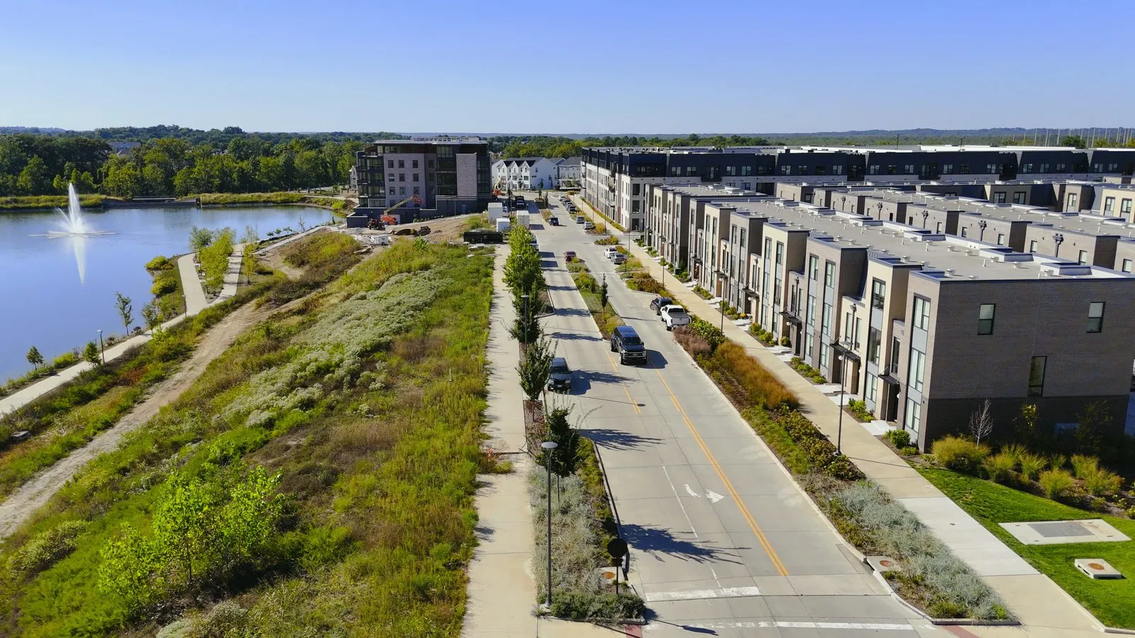 New townhomes along a street beside the lake at Wildhorse Village in Chesterfield, Missouri