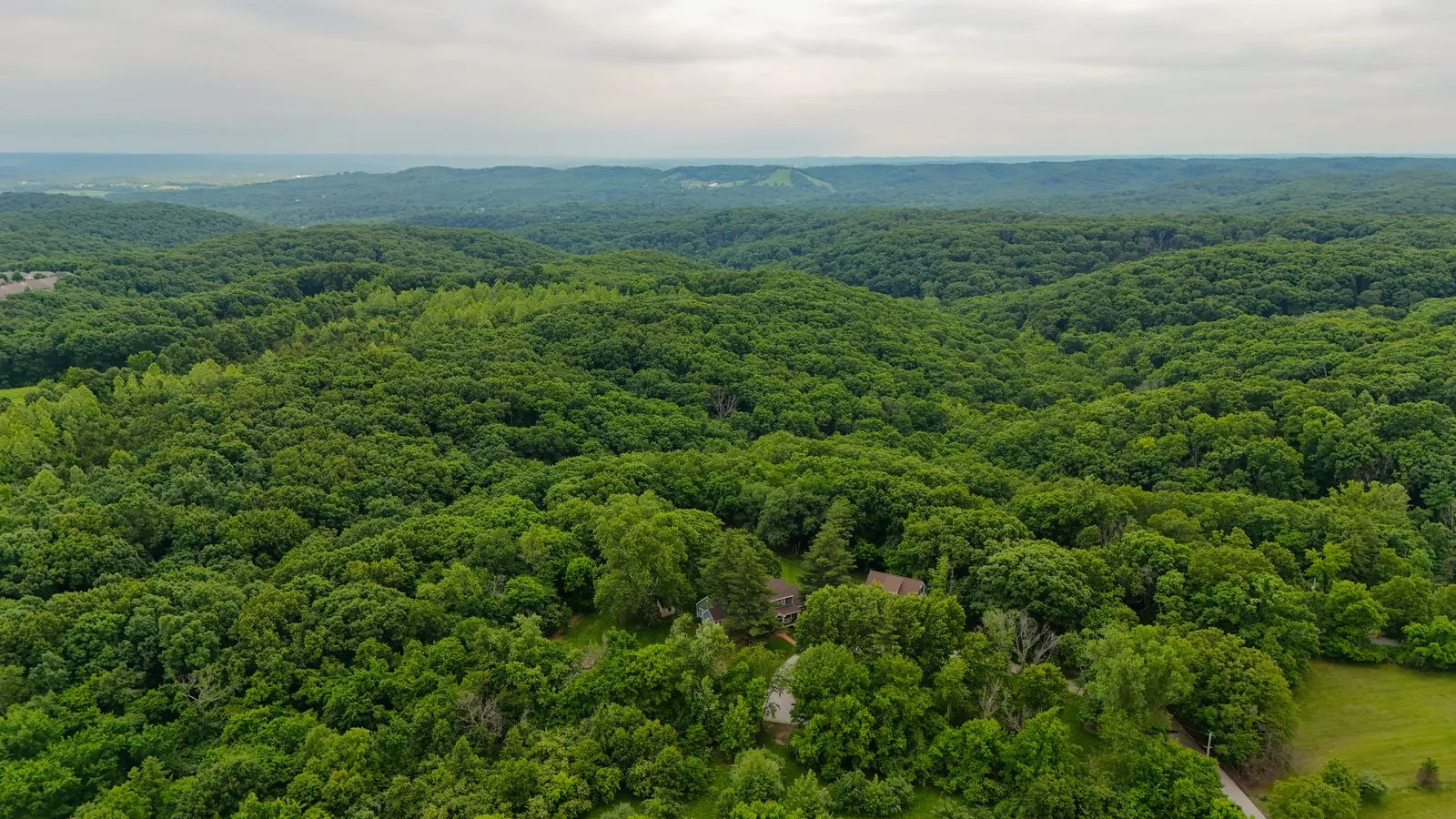 Aerial view of the rolling wooded hills of rural Wildwood, Missouri