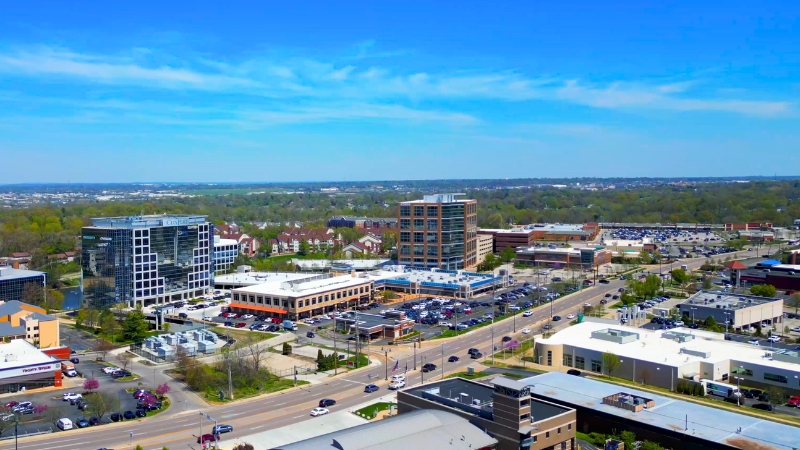 Buildings, parking lots, and a busy commercial road
