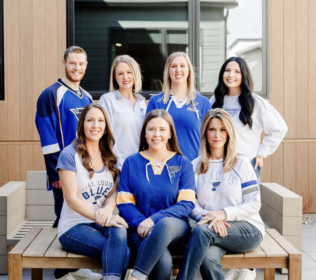 seven people wearing blues jerseys